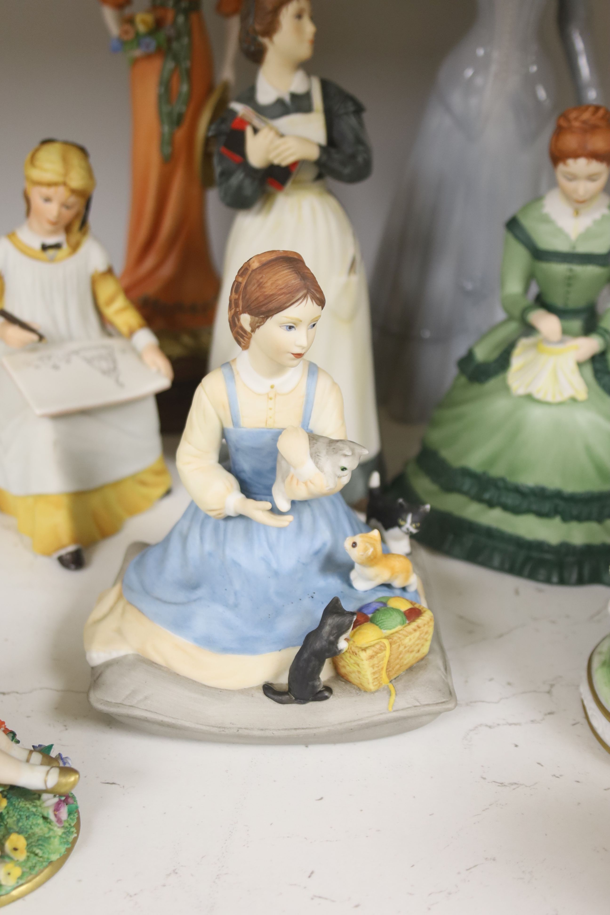 A German porcelain group of two children by a tree stump, on rocky base, two 'crinoline' figures and six other porcelain groups